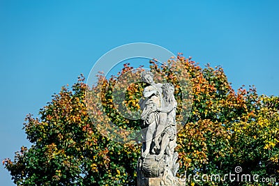 Classic statue in a park with blue sky and tree on background Editorial Stock Photo